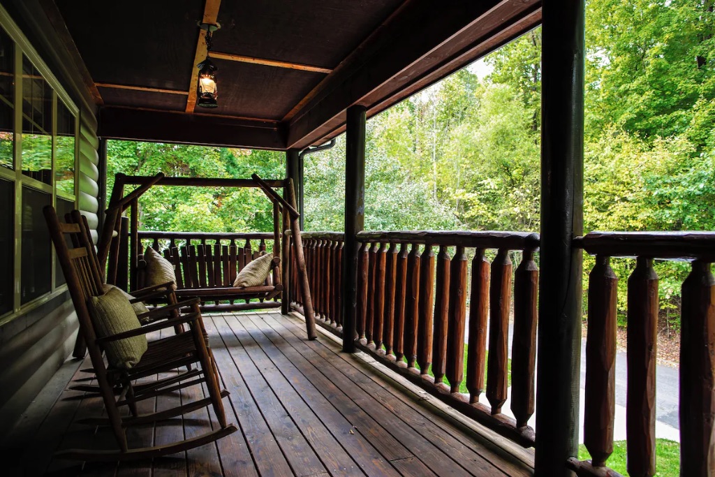 Pigeon Hills covered deck with rocking chairs porch swing and forest mountain views