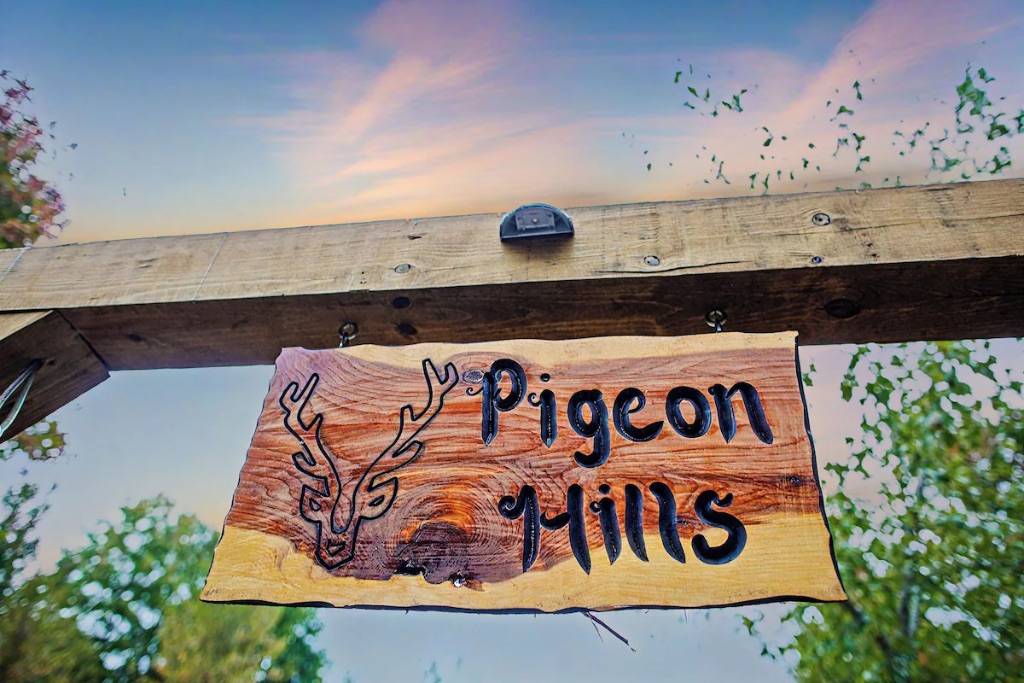 Pigeon Hills Tennessee custom wood sign with deer antler logo and mountain sunset sky