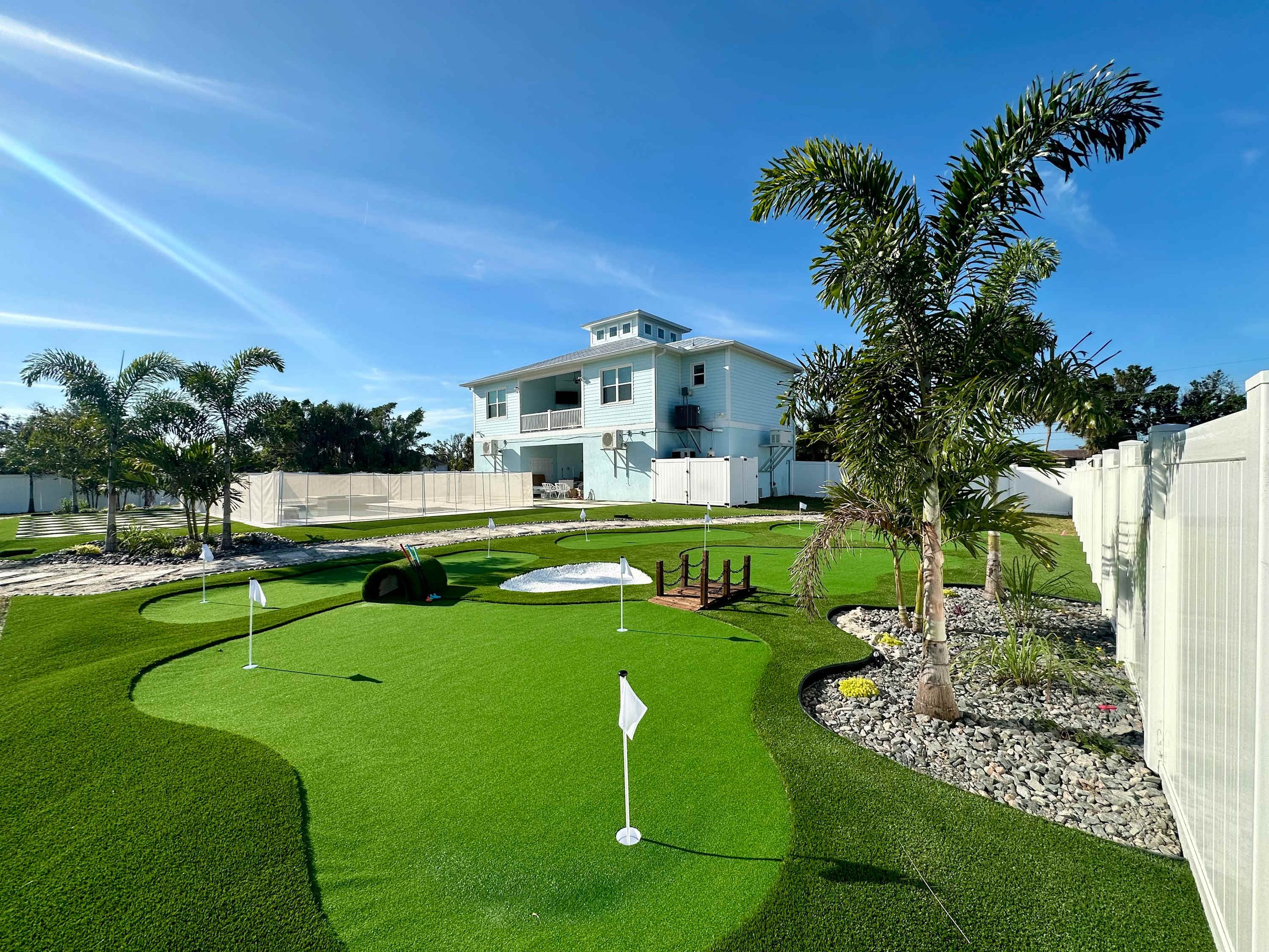 Seaside Boca resort-style pool with tropical landscaping and outdoor living spaces